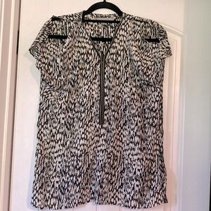 Peek- a-boo shoulder blouse with working zipper in front.